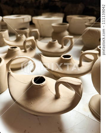 Clay blanks for a kerosene lamp in a pottery workshop. Close up photo Clay blanks for a kerosene lamp in a pottery workshop. Close up photo 111139042