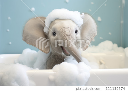 Cute baby elephant in a bathtub with soapy foam in the tub. 111139374