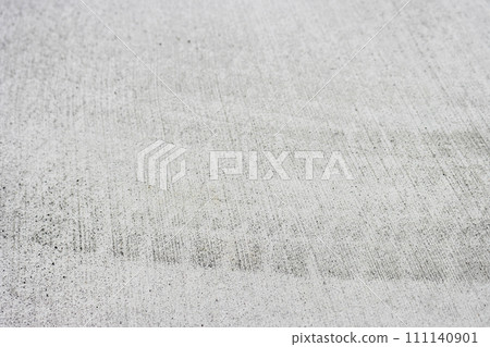 Car tire tracks on new concrete 111140901