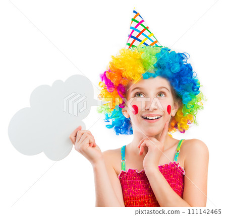 Lively little girl in bright colouful clown wig holding white speech bubble isolated on white background 111142465