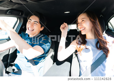 A young couple enjoying a drive in short sleeves on a summer day 111142828