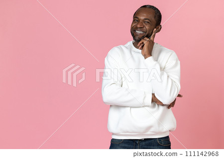 Smiling black man wearing white sweatshirt holding chin 111142968