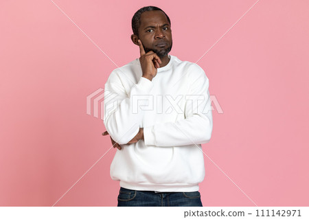 Pensive black man wearing white sweatshirt thinking holding chin Pensive black man wearing white sweatshirt thinking holding chin 111142971