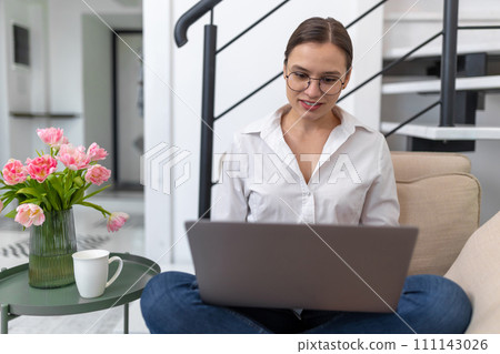 Woman freelancer working online in home interior. Woman freelancer working online in home interior. 111143026