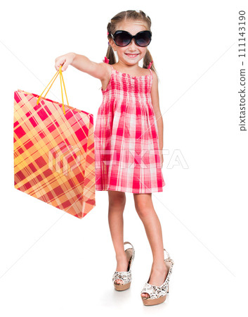 Smiling little girl in mother glasses and shoes with shopping bag isolated on a white background Smiling little girl in mother glasses and shoes with shopping bag isolated on a white background 111143190