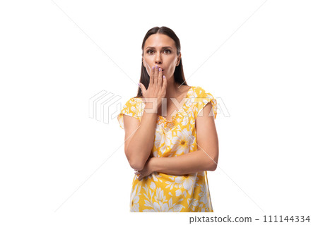 close-up portrait of a young Caucasian woman in a yellow summer T-shirt with surprise on her face 111144334