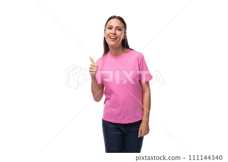 young positive happy slim woman dressed in a pink t-shirt. corporate clothing concept young positive happy slim woman dressed in a pink t-shirt. corporate clothing concept 111144340