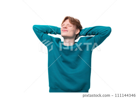 satisfied student guy with red hair guy dressed in a blue sweater on a white background satisfied student guy with red hair guy dressed in a blue sweater on a white background 111144346