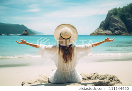 Young woman in white dress and hat sitting on the beach Young woman in white dress and hat sitting on the beach 111144460