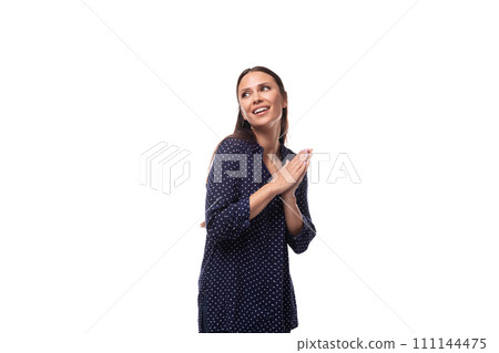 young brunette advertiser woman dressed in a blue blouse with a polka dot pattern looks happy and 111144475