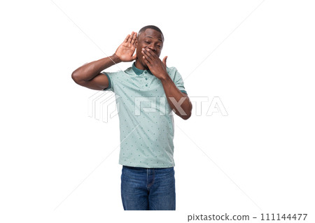 young cute american guy dressed in a mint t-shirt listens to the sound 111144477