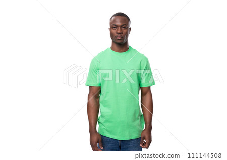 young american man dressed in a green corporate t-shirt on a white background with copy space 111144508