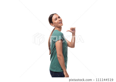 young beautiful brunette lady with a ponytail hairstyle is dressed in a green t-shirt and jeans on a young beautiful brunette lady with a ponytail hairstyle is dressed in a green t-shirt and jeans on a 111144519