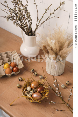 preparation for Easter. painted Easter eggs in kitchen on wooden countertop preparation for Easter. painted Easter eggs in kitchen on wooden countertop 111144586