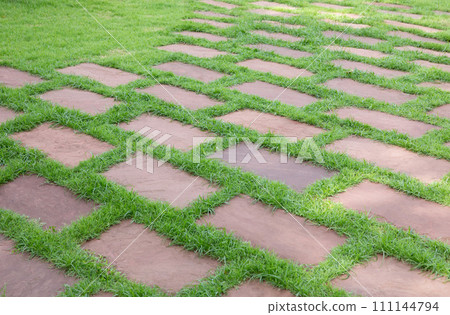 Green grass with stone tiled floor pattern. Green grass with stone tiled floor pattern. 111144794