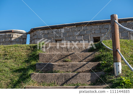 Stone steps with wooden fence to Suwon Hwaseong Fortress Wall, which is surrounding the center of Suwon, the provincial capital of Gyeonggi-do, in South Korea 111144885