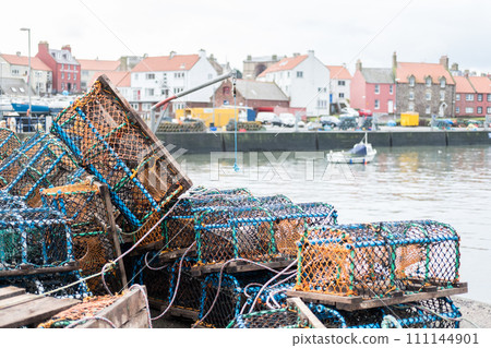 Group of fist net traps with building on the background 111144901