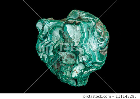 Macro of a mineral stone Malachite on a black background 111145283