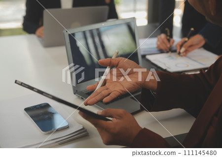 Business team meeting working with new startup project, discussion and analysis data the charts and graphs. Digital tablet, calculator, laptop computer using, Business finance and accounting concept. 111145480