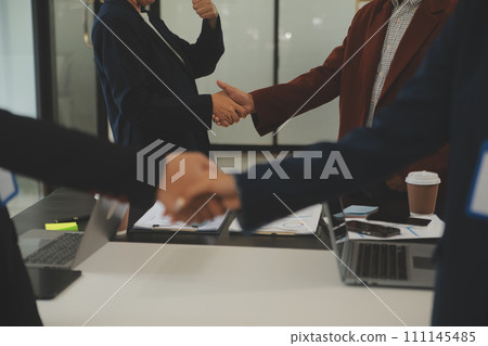 Meeting and greeting concept, Two confident Business handshake and business people after discussing good deal of Trading contract and new projects for both companies, success, partnership, co worker. 111145485