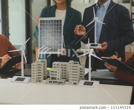 Close-up at tablet, Engineers pointing at tablet with their hands. To jointly design the use of renewable energy with wind and solar energy. Concept of using renewable energy. Close-up at tablet, Engineers pointing at tablet with their hands. To jointly design the use of renewable energy with wind and solar energy. Concept of using renewable energy. 111145514