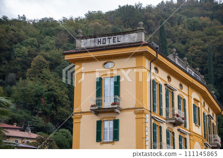 Narrow building of a picturesque little hotel 111145865