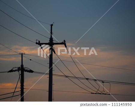 Telephone pole dyed in the sunset Telephone pole dyed in the sunset 111145950