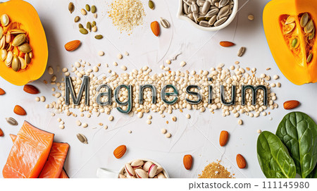 Magnesium title text food lettering from seeds on the table with pumpkin, herbs, red fish, vegetables full of magnesium vitamins 111145980