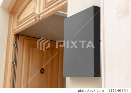 Wall-mounted black signboard on a textured wall, ideal for businesses to display their brand logo or promotional content. Black signage mockup. 111146364