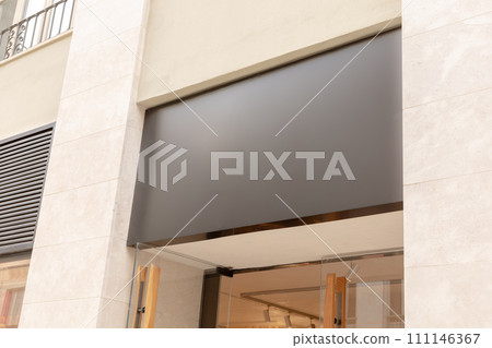 Sleek, modern storefront awning provides a perfect blank canvas for a business's text or logo, ideal for brand marketing visuals. Black signboard mockup. 111146367