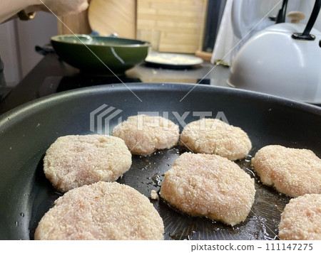 Delicious meat cutlets are being fried in a frying pan in the kitchen Delicious meat cutlets are being fried in a frying pan in the kitchen 111147275