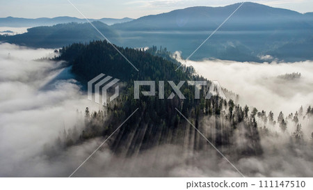 Foggy landscape on the hills in a cold morning seen from the mountains 111147510