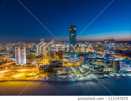 Yekaterinburg city with Buildings of Regional Government and Parliament, Dramatic Theatre, Iset Tower, Yeltsin Center, panoramic view at winter sunset. Yekaterinburg city with Buildings of Regional Government and Parliament, Dramatic Theatre, Iset Tower, Yeltsin Center, panoramic view at winter sunset. 111147870