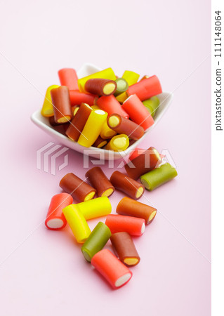 Colorful sweet jelly candies on pink background. Colorful sweet jelly candies on pink background. 111148064