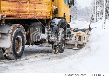 A snowplow is shoveling snow on the street, severe winter with lot of snow 111148179