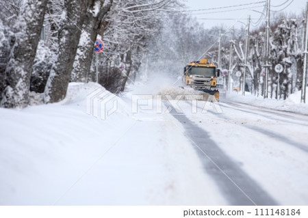 Shoveling snow from the road and blowing snow, snowy roads on a winter day Shoveling snow from the road and blowing snow, snowy roads on a winter day 111148184