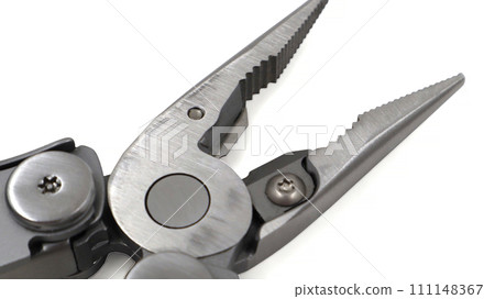 One modern gray iron open folding multifunctional knife on a white background. Multi-tool with advanced tools. Pliers close up. Compact and portable product. Pocket knife. EDC concept. Copy space One modern gray iron open folding multifunctional knife on a white background. Multi-tool with advanced tools. Pliers close up. Compact and portable product. Pocket knife. EDC concept. Copy space 111148367