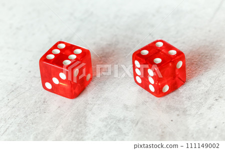 Two translucent red craps dices on white board showing Easy Ten (number 6 and 4) Two translucent red craps dices on white board showing Easy Ten (number 6 and 4) 111149002