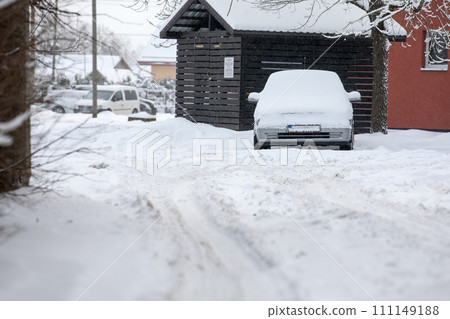 Snowy yard on winter day, car covered with snow Snowy yard on winter day, car covered with snow 111149188