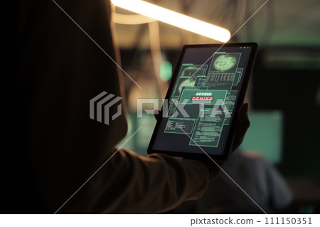 Access denied message on digital tablet screen, unsuccessful password cracking, database hacking fail. Cyberattack, internet thief stealing electronic information, using malicious software 111150351