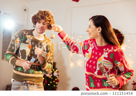 Happy young couple lover enjoy dancing in kitchen and making desserts to celebrate Christmas. Happy young couple lover enjoy dancing in kitchen and making desserts to celebrate Christmas. 111151454
