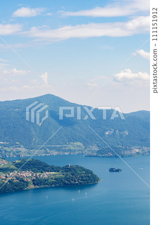 Mountain landscape, picturesque mountain lake in the summer morning, large panorama. Iseo, Italy Mountain landscape, picturesque mountain lake in the summer morning, large panorama. Iseo, Italy 111151912