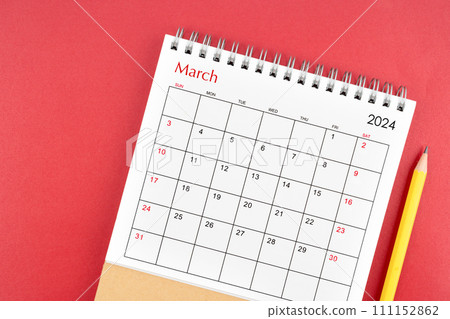 March 2024 desk calendar and pencil on red background. March 2024 desk calendar and pencil on red background. 111152862