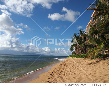 Kaanapali Beach with trees, hotels, and Lanai in the distance 111153104