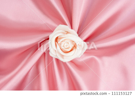 Pink satin fabric texture background with rose flower is center position. Pink satin fabric texture background with rose flower is center position. 111153127