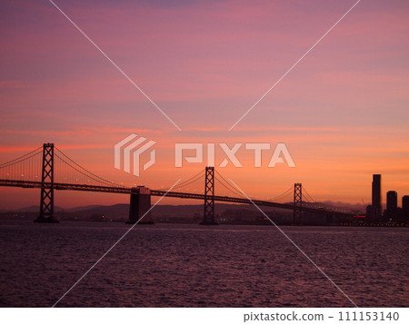 San Francisco side of Bay Bridge and downtown San Francisco at Dusk with amazing reds 111153140