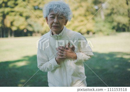 A woman in her 60s in a park with chest pain A woman in her 60s in a park with chest pain 111153518