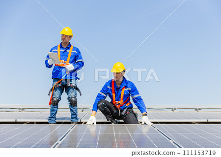 Technicians are installing and inspecting standards of solar panels on roof of an industrial. 111153719