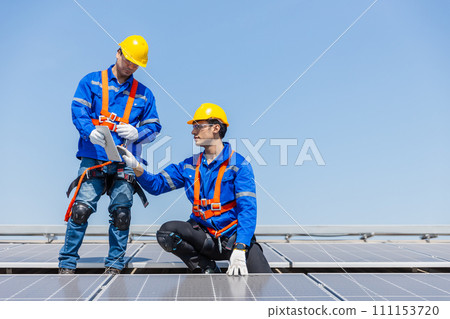 Technicians are installing and inspecting standards of solar panels on roof of an industrial. Technicians are installing and inspecting standards of solar panels on roof of an industrial. 111153720