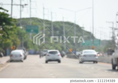 highway traffic with safety barrier on road asphalt, blurred image 111154389
